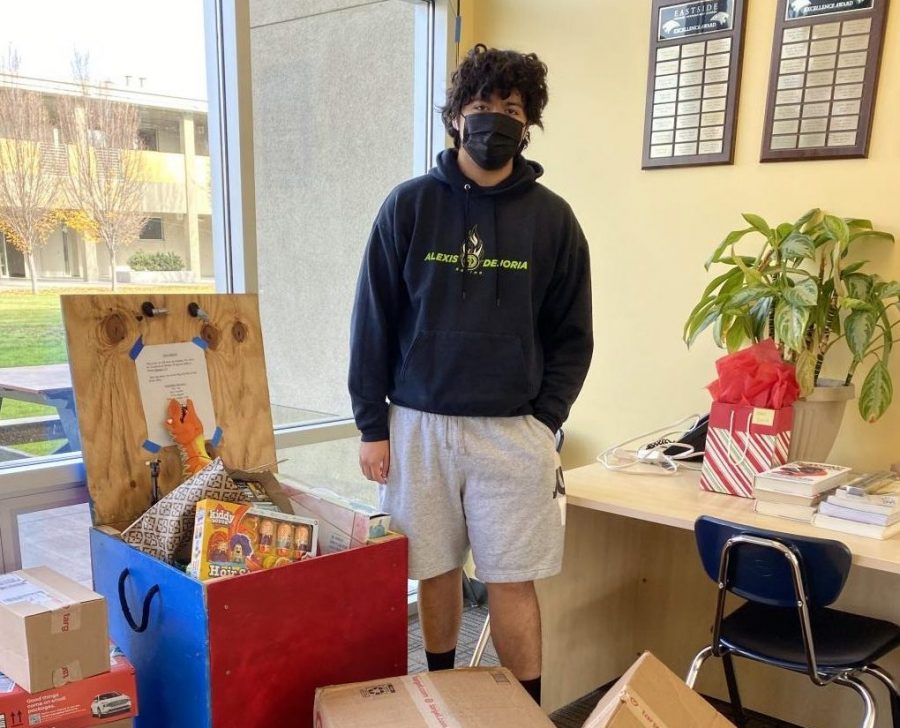 Sophomore Juan Ibarra admires the collected toys in the front office. 